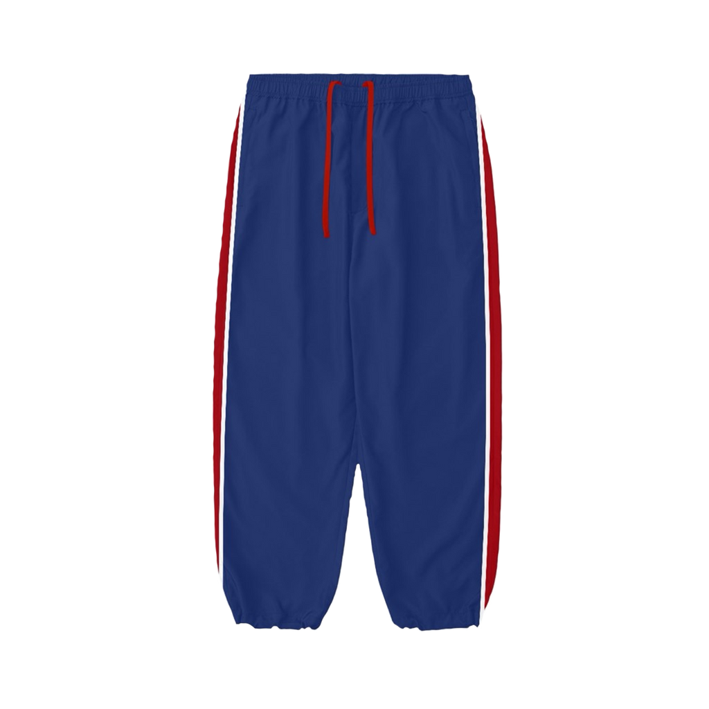 Blue unisex trackpants feature red and white stripes down the side of each leg.